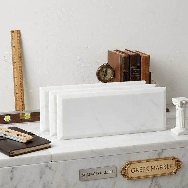 White rectangular marble bookends with subtle veining in Thassos White 4x12 deep-beveled polished-honed finish