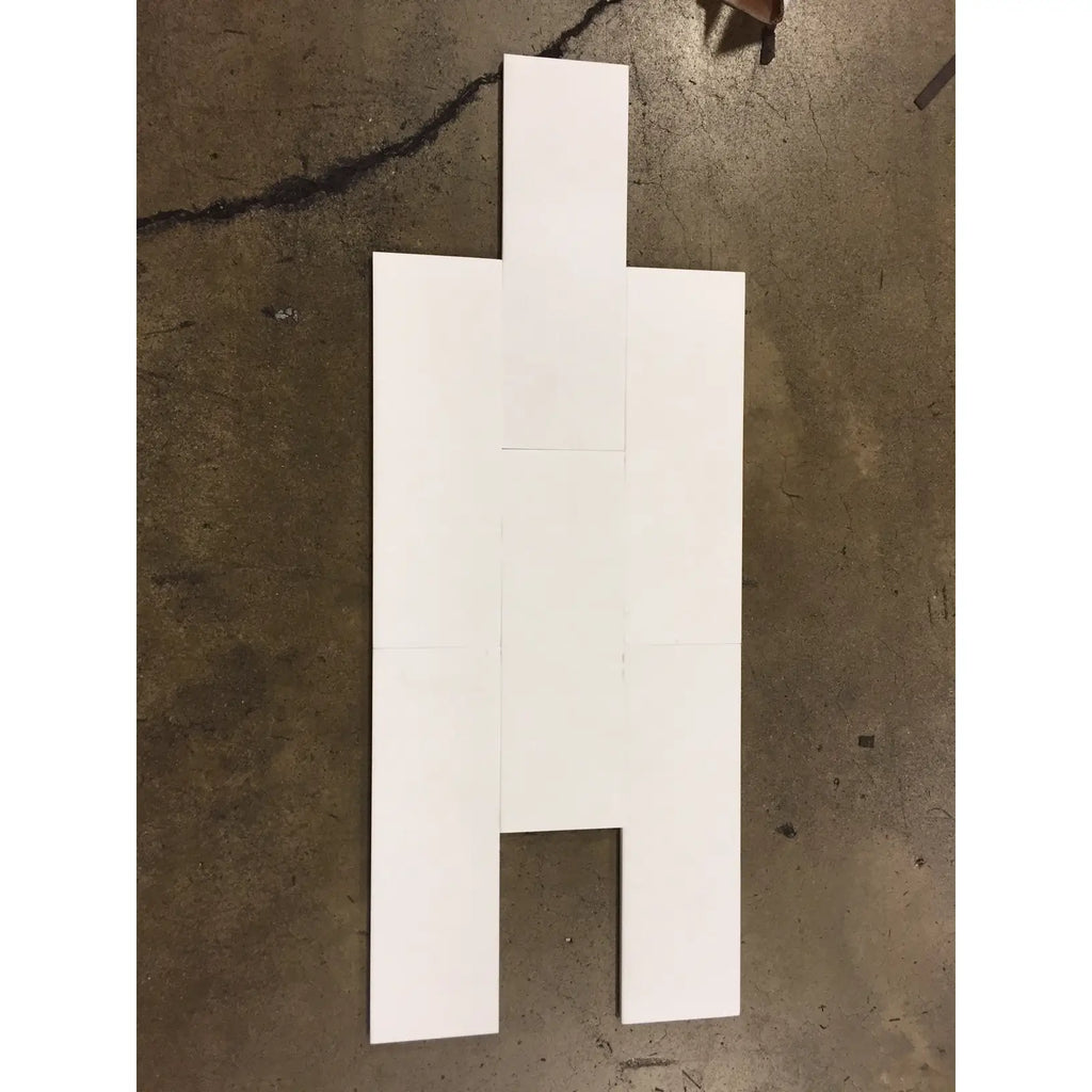 White cardboard cutout figure used as a display for Thassos White 4X12 Marble in polished or honed finish