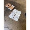 Patterned Thassos White Berlinetta mosaic marble tiles with a cardboard box display