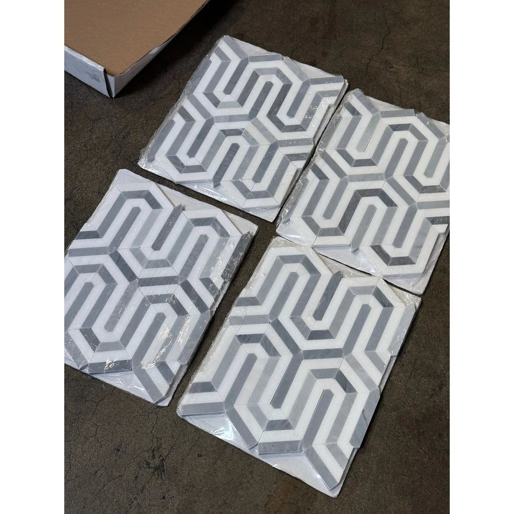 Four geometric patterned Thassos White Berlinetta mosaic marble tiles with blue-gray accents