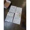 Four geometric patterned Thassos White Berlinetta Design mosaic marble tiles with blue-gray accents