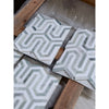 White and gray geometric mosaic marble tiles with raised interlocking pattern in thassos white berlinetta design