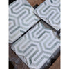 Geometric mosaic tiles in white and gray marble with interlocking zigzag designs from thassos white berlinetta ming-green collection