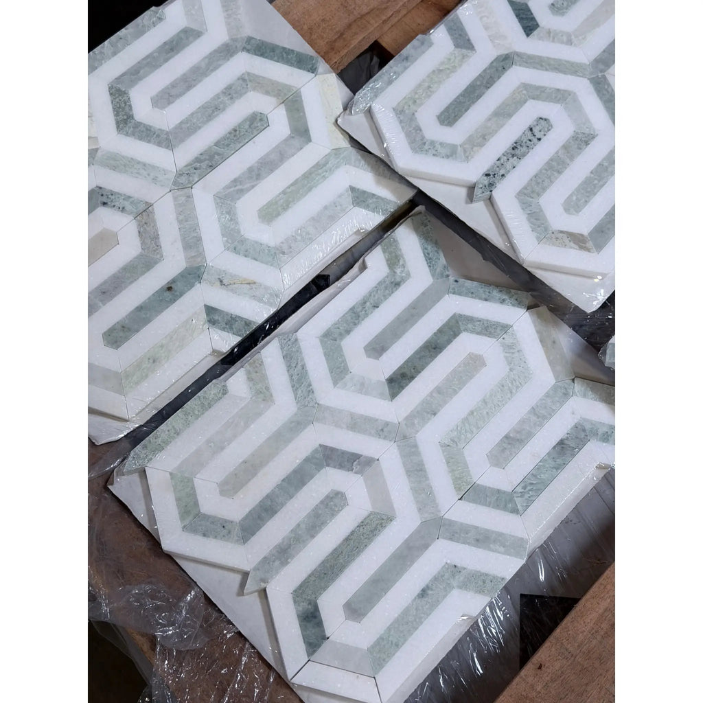 Geometric mosaic tiles in white and gray marble with interlocking zigzag designs from thassos white berlinetta ming-green collection