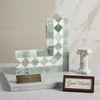 L-shaped bookends in polished green and white Thassos marble with geometric diamond pattern for stylish organization