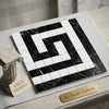 Black and white marble mosaic tile with a polished geometric Greek key pattern corner border in Thassos white and black