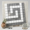 A sleek square mosaic tile panel with a checkerboard pattern of white and gray thassos marble tiles