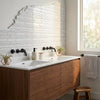Modern double-sink vanity with rich walnut finish and white thassos white manhattan mosaic marble countertop with black faucets