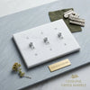 Thassos white marble triple toggle plate switch wall plate with silver toned hardware and three toggle switches