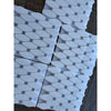 Thassos white octave long octagon mosaic marble tiles with blue-gray accent squares wrapped in clear plastic