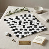 Thassos white penny-round black and white marble mosaic tile arranged in a yin-yang pattern polished or honed