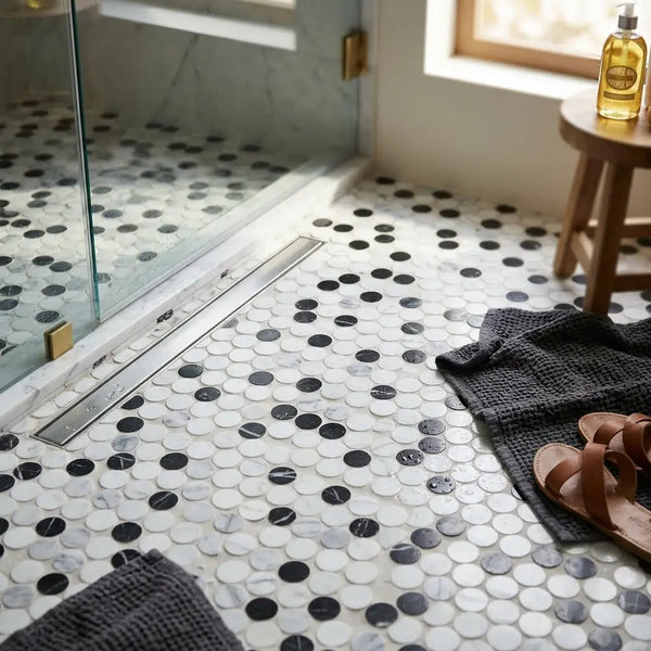 Black and white marble penny round mosaic tile floor featuring Thassos white polished Carrara and black marble