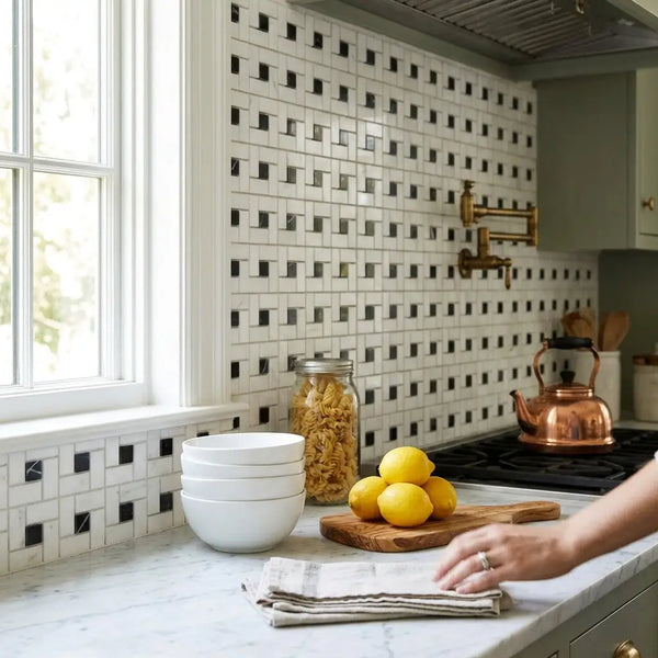 Stack of white ceramic bowls displayed with thassos white pinwheel mosaic black marble polished or honed tiles