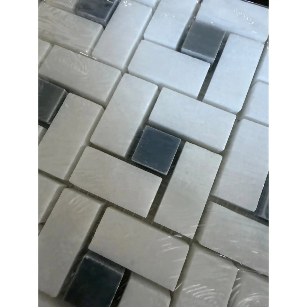 Thassos white pinwheel mosaic with blue-gray marble tiles in white and dark gray arranged in herringbone pattern wrapped in plastic