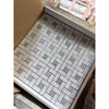 Thassos white pinwheel mosaic marble tile set in white and gray woven pattern packaged for installation