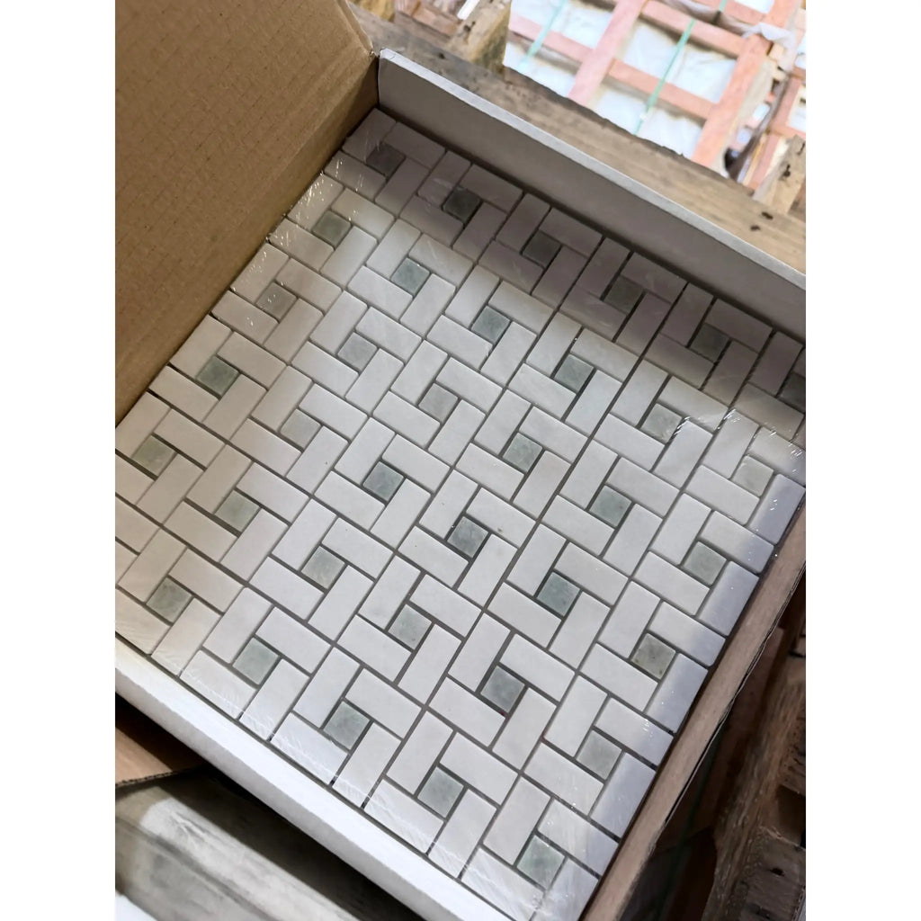 Thassos white pinwheel mosaic marble tile set in white and gray woven pattern packaged for installation