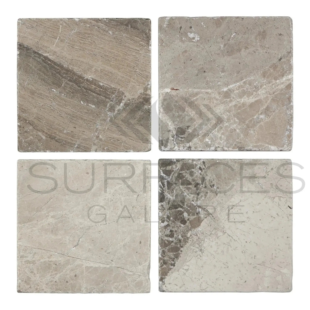 Four square Tundra Gray 12X12 Marble Tumbled tiles showcasing a sleek design