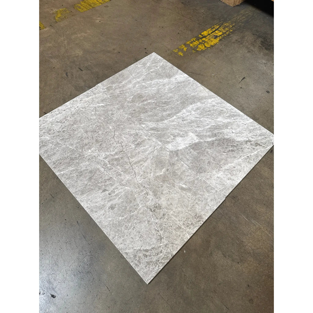 Light gray Tundra Gray 12x24 marble tile with intricate white and darker gray veining