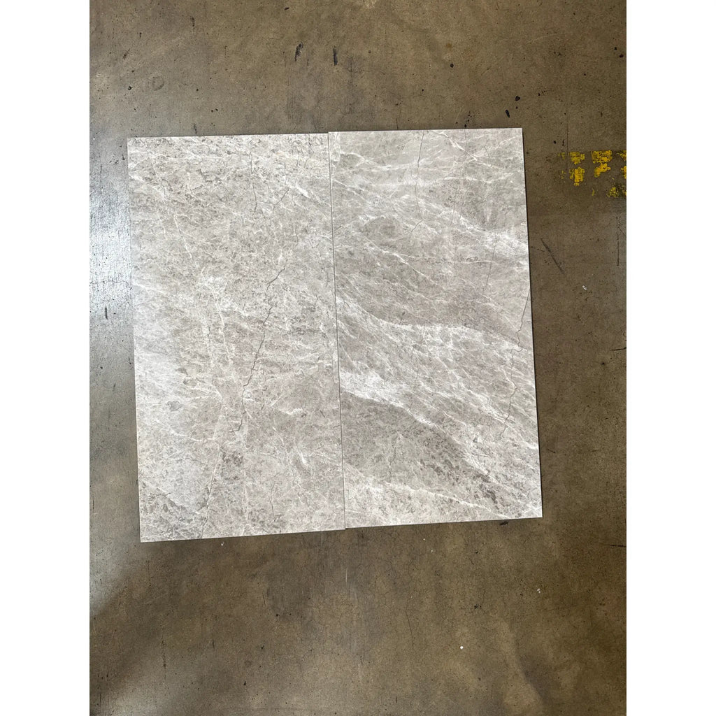 Light gray marble tiles with intricate white and dark gray veining for Tundra Gray 12x24 product