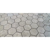Gray hexagonal marble mosaic tiles in tundra gray with subtle veining and a matte honed finish for flooring or walls