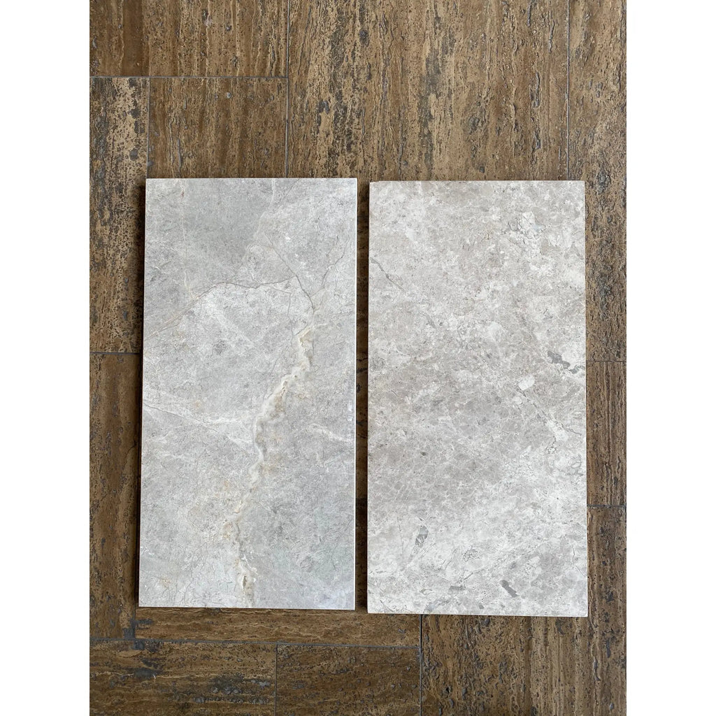 Two gray marble-patterned Tundra Gray tiles for Single-Step Chair Rail Trim