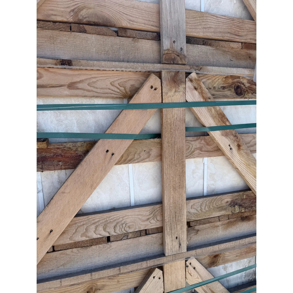 Wooden crate with green straps containing Valencia Travertine 18x18 filled and honed tiles