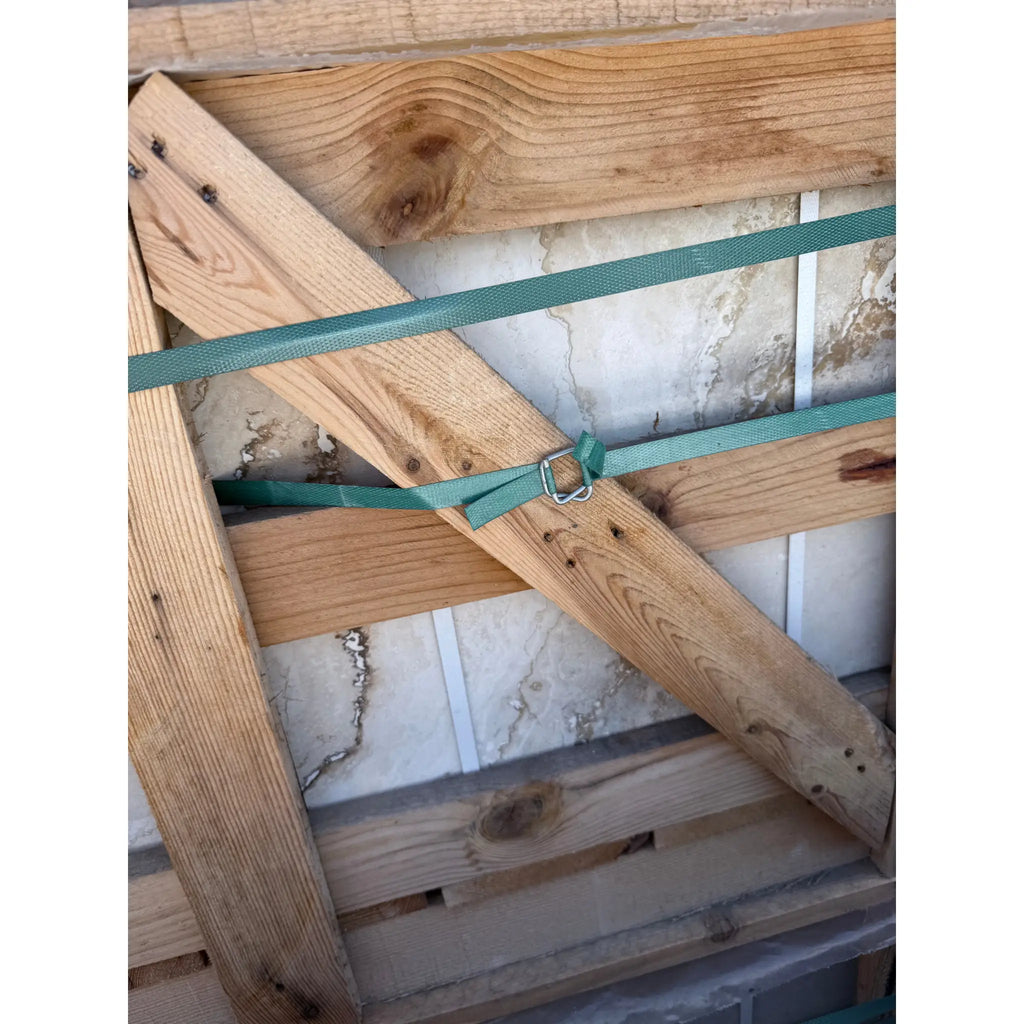 Wooden-framed marble slab secured with green strapping for Valencia Travertine 18x18