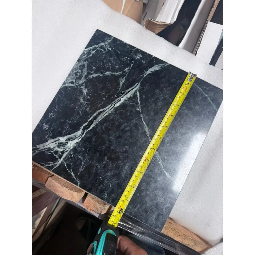 Black verde alpi empress green marble 12x12 polished tile with white veining measured by yellow tape measure