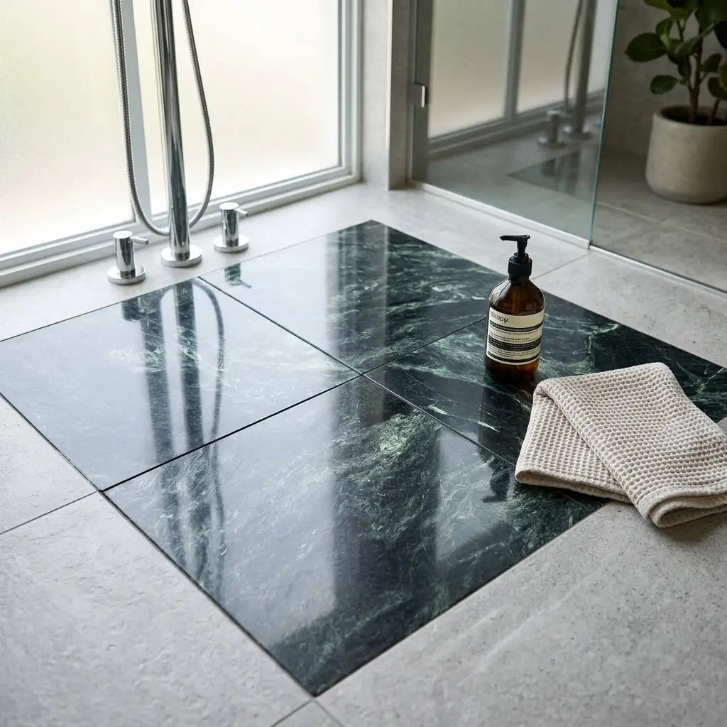 Dark green polished verde alpi empress green marble 12x12 tiles with subtle veining covering bathroom floor