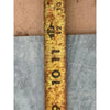 Rusty yellow measuring tape next to Verde Alpi Green Marble Tumbled product