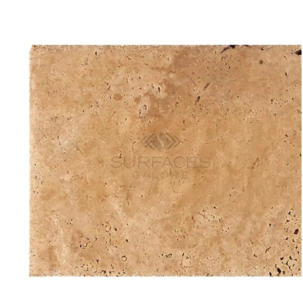 Beige travertine tile in Walnut Travertine 16X24, unfilled, brushed, and chiseled-edge