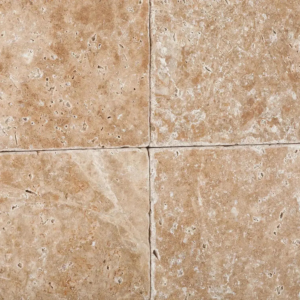 Four Walnut Travertine 6X6 Tumbled tiles showcasing natural stone texture