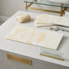 Creamy white polished white onyx marble slab with soft peach veining in 12x24 cross-cut vanilla onyx design