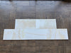 White Onyx Vanilla Onyx cross-cut 12x24 polished marble tiles on wood floor