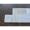 White Onyx Vanilla Onyx cross-cut 12x24 marble tile on dark wood floor