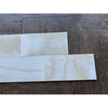 White Onyx Vanilla Onyx 12x24 polished tiles on dark wood floor
