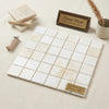 Beige Turkish marble mosaic tile panel with subtle veining and polished finish in white onyx cross-cut 2x2 design
