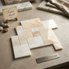 Beige and cream turkish marble tiles with subtle veining in a staggered pattern white onyx vanilla onyx opus mosaic