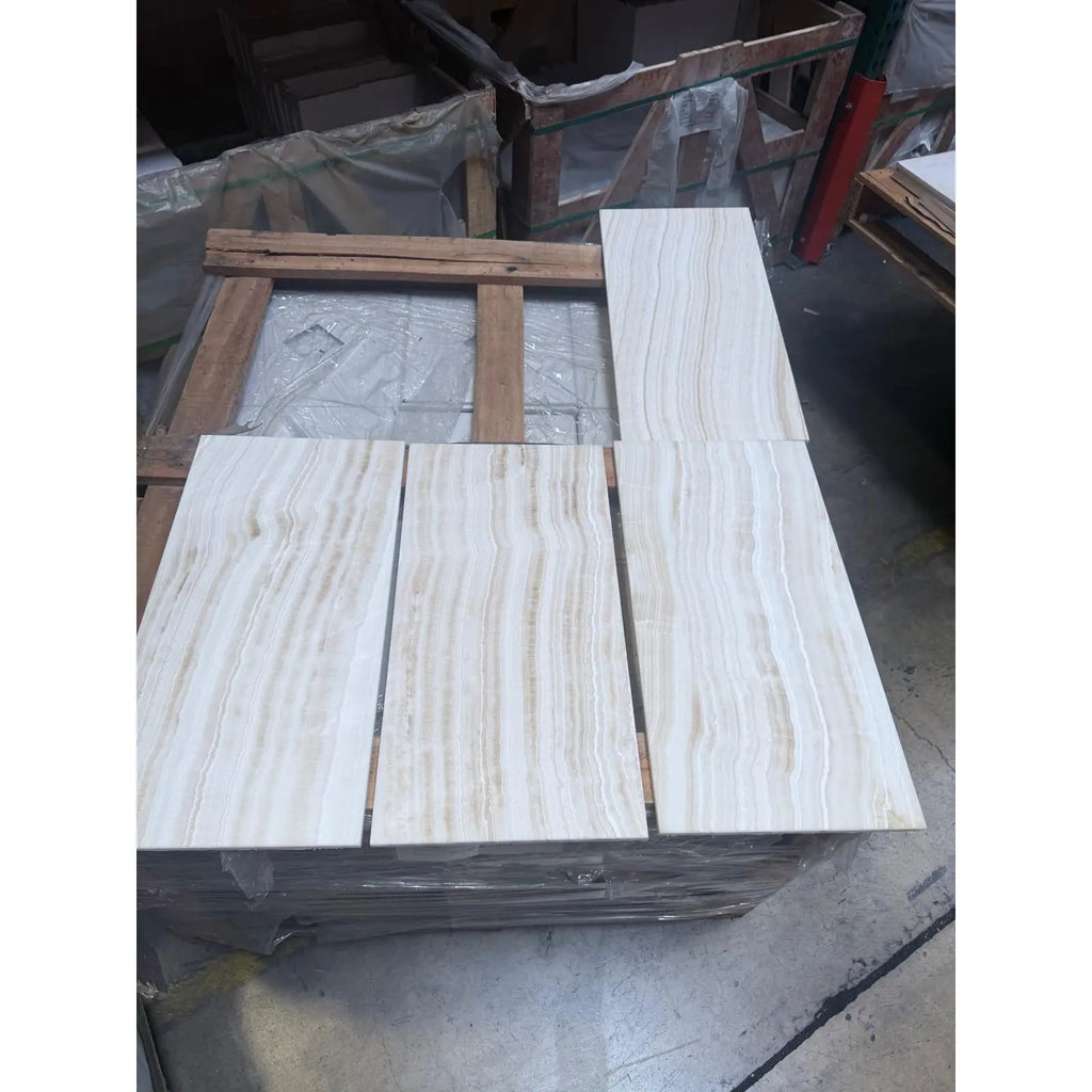 Stacked White Onyx Bianco-Vanilla marble-patterned tiles in polished mosaic design