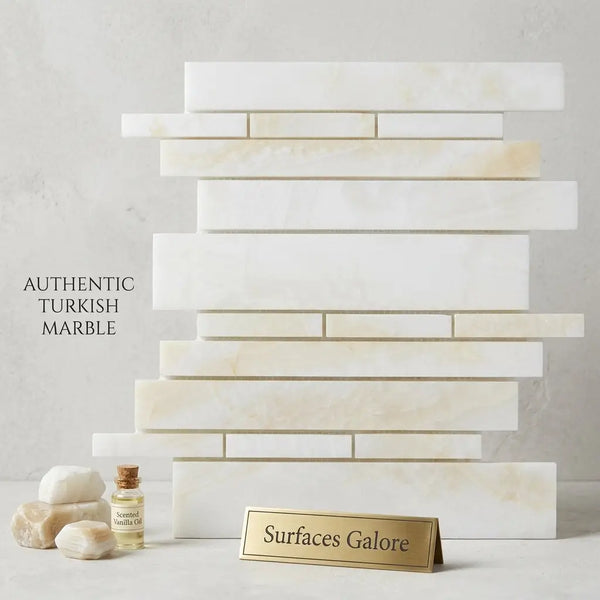 Stacked rectangular polished white onyx mosaic marble tiles in creamy white with subtle golden veining cross cut design