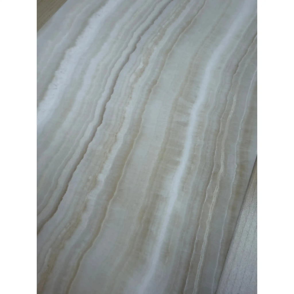 White onyx slab with prominent veining from White Onyx Bianco-Vanilla 12x24 marble polished