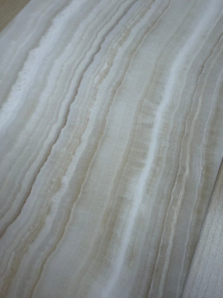 White onyx slab with prominent veining from White Onyx Bianco-Vanilla 12x24 marble polished