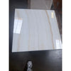 A polished 18x18 white onyx marble tile with glossy white surface and subtle beige veining called vanilla onyx vein-cut