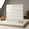 A sleek square slab of white onyx vanilla onyx vein-cut turkish marble with polished surfaces and subtle beige veining