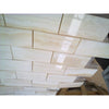 Beige marble subway tiles with subtle veining and a glossy finish in white onyx vein-cut 2x4 mosaic polished design