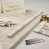 Cream-colored Turkish marble countertop with subtle veining and polished finish in white pearl Botticino pencil liner molding