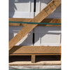 A light brown wooden pallet with a green strap securing white pearl botticino beige marble 12x12 polished or honed tiles
