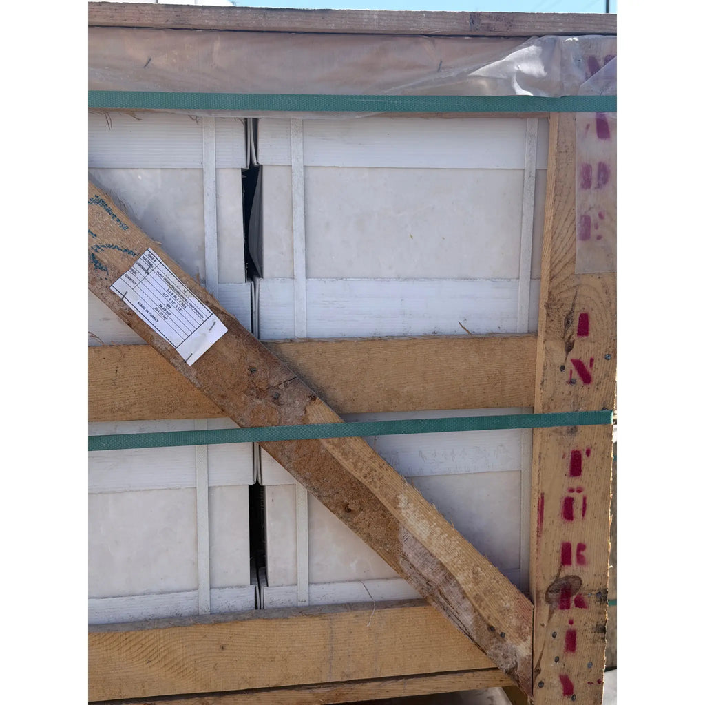 White pearl botticino beige marble 12x12 polished or honed tiles secured in a wooden crate with green strapping