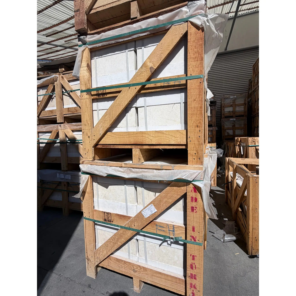 Stacked wooden pallets secure white pearl botticino beige marble 12x12 polished or honed tiles with green straps and plastic wrap