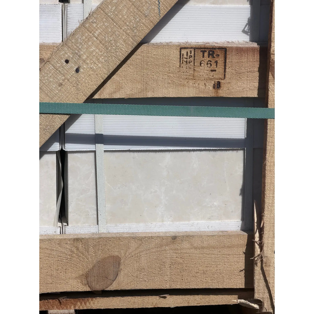 A beige textured white pearl botticino marble panel 12x12 polished with a white stripe framed by wooden beams secured with straps